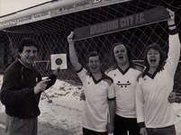 Charles I (Keith Jowett, Trevor Jones, John Jowett) pose with Bradford City Football Club manager Roy McFarland, holding a copy of their single, Glory! Bradford City.
